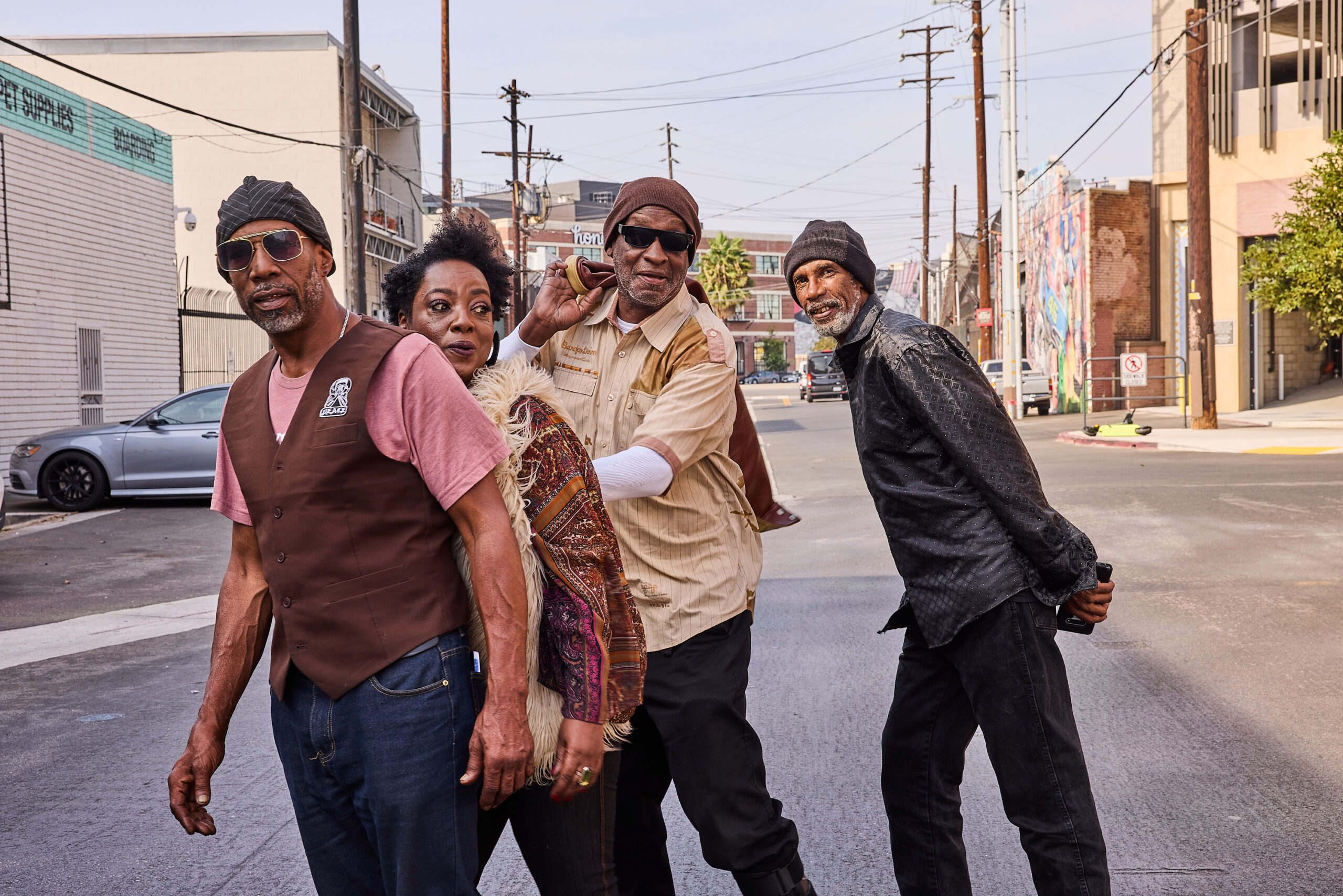A musician group posing for photos in the arts district of Los Angeles