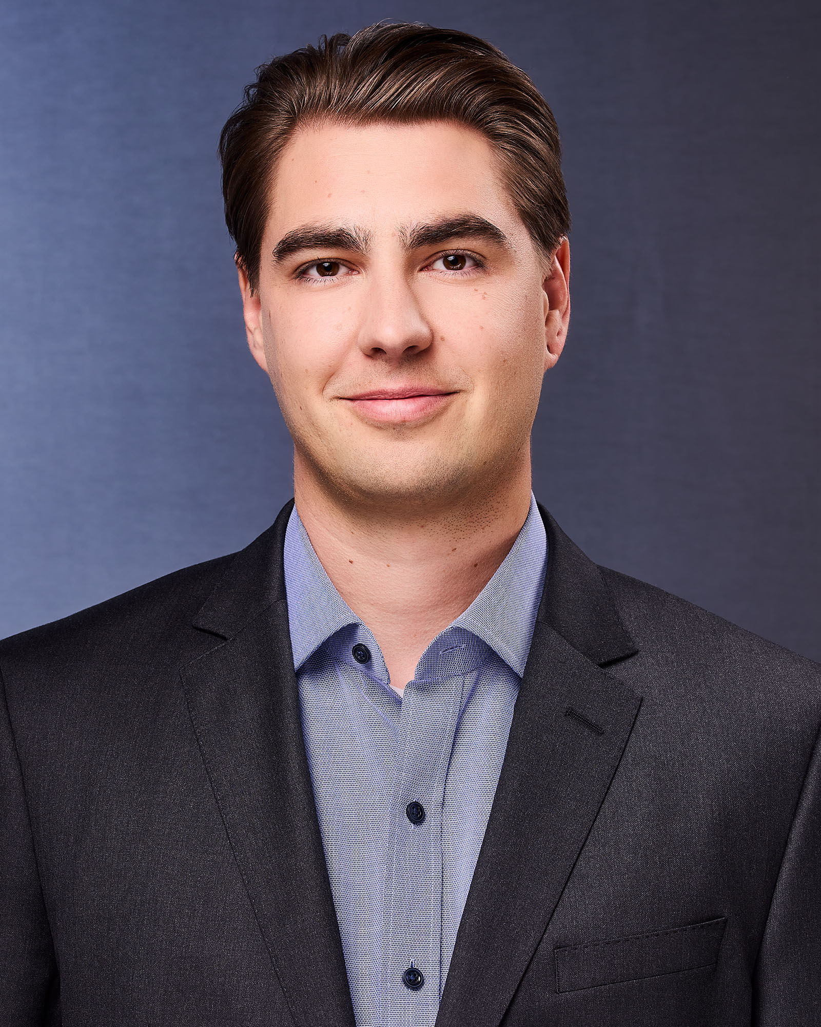 a corporate headshot of a man in a suit made by The Light Committee