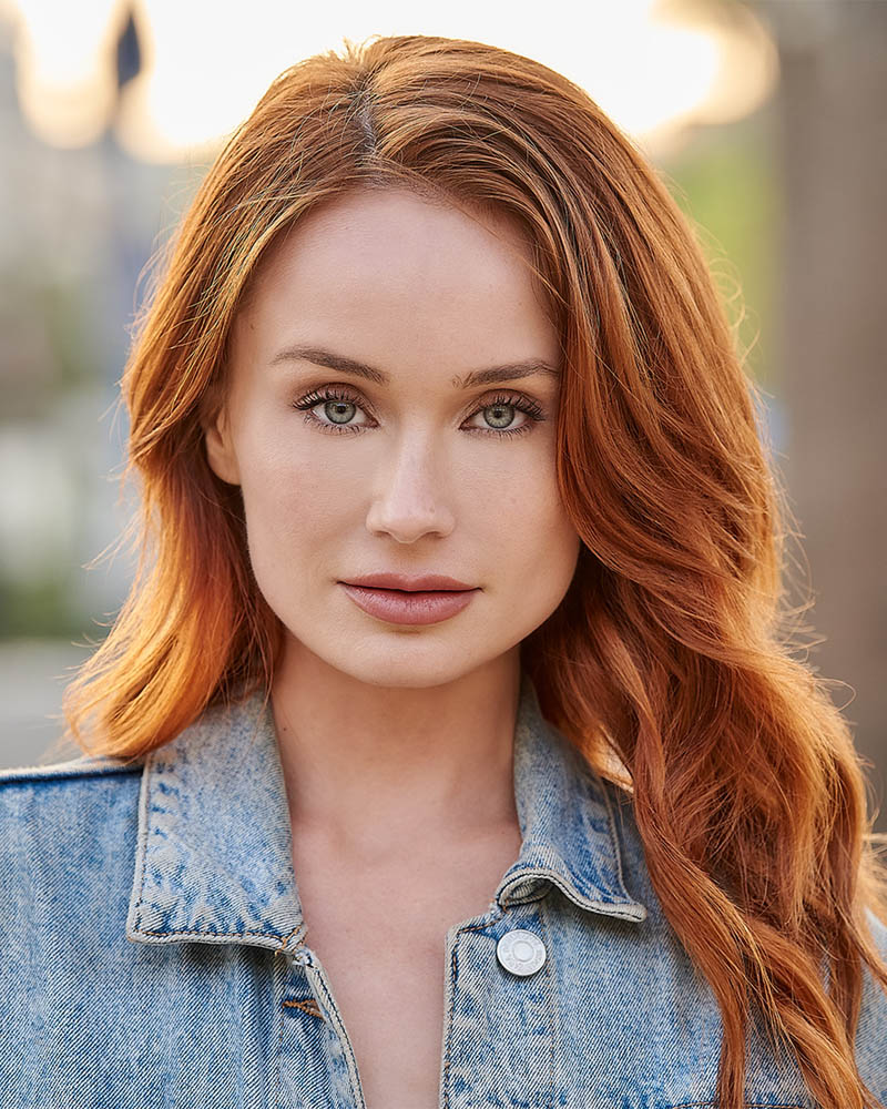 A headshot of a woman in a jean jacket outdoors with natural light in Glendale, CA