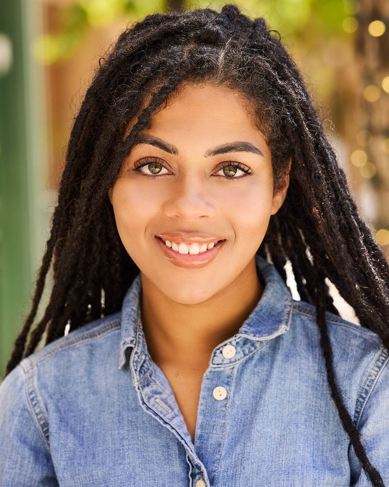 A commercial actor headshot of a black woman in natural light outside near Pasadena, Calif.