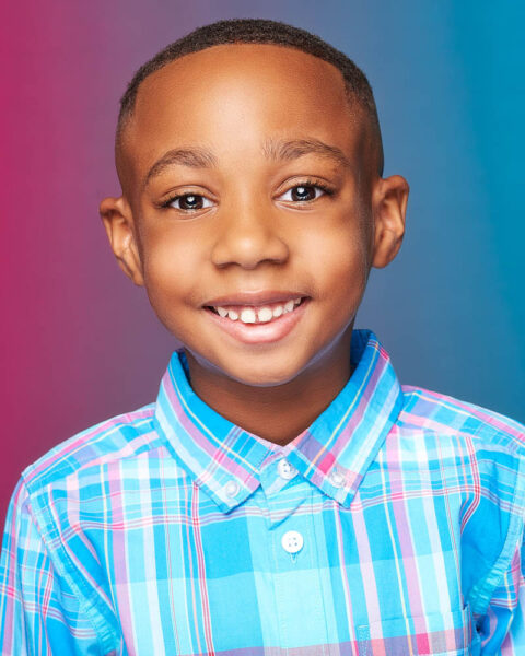 young boy commercial acting headshot in a studio near Pasadena with a colorful background