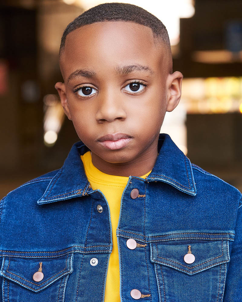 young boy theatrical acting headshot outside near Glendale, CA with a natural light background