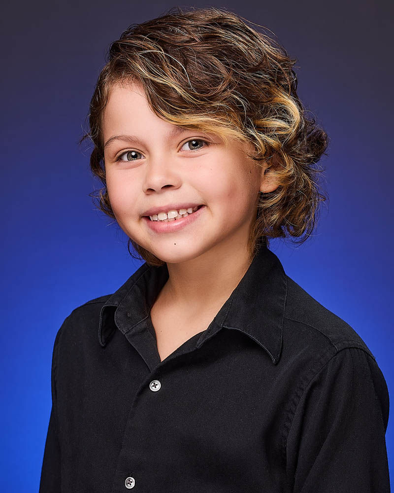 young girl acting headshot in a studio near NoHo with a blue background