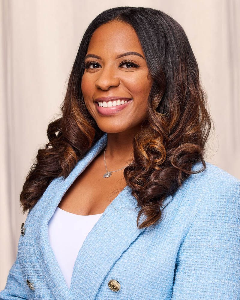 A corporate headshot of a black woman in a suit in studio near LA