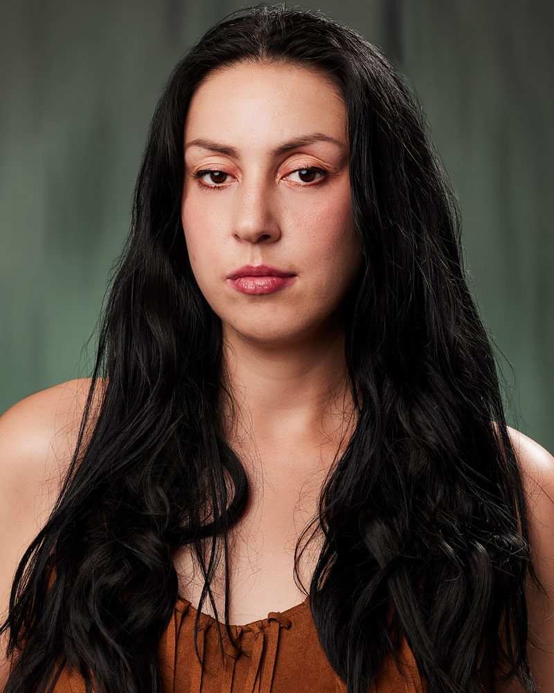 black hair woman in a theatrical actior headshot Los Angeles