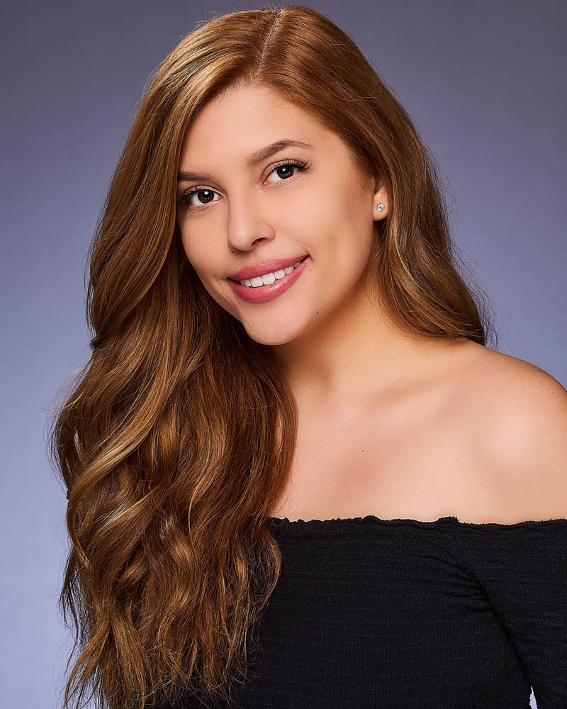 A commercial actor headshot of a woman smiling in a studio near Beverly Hills