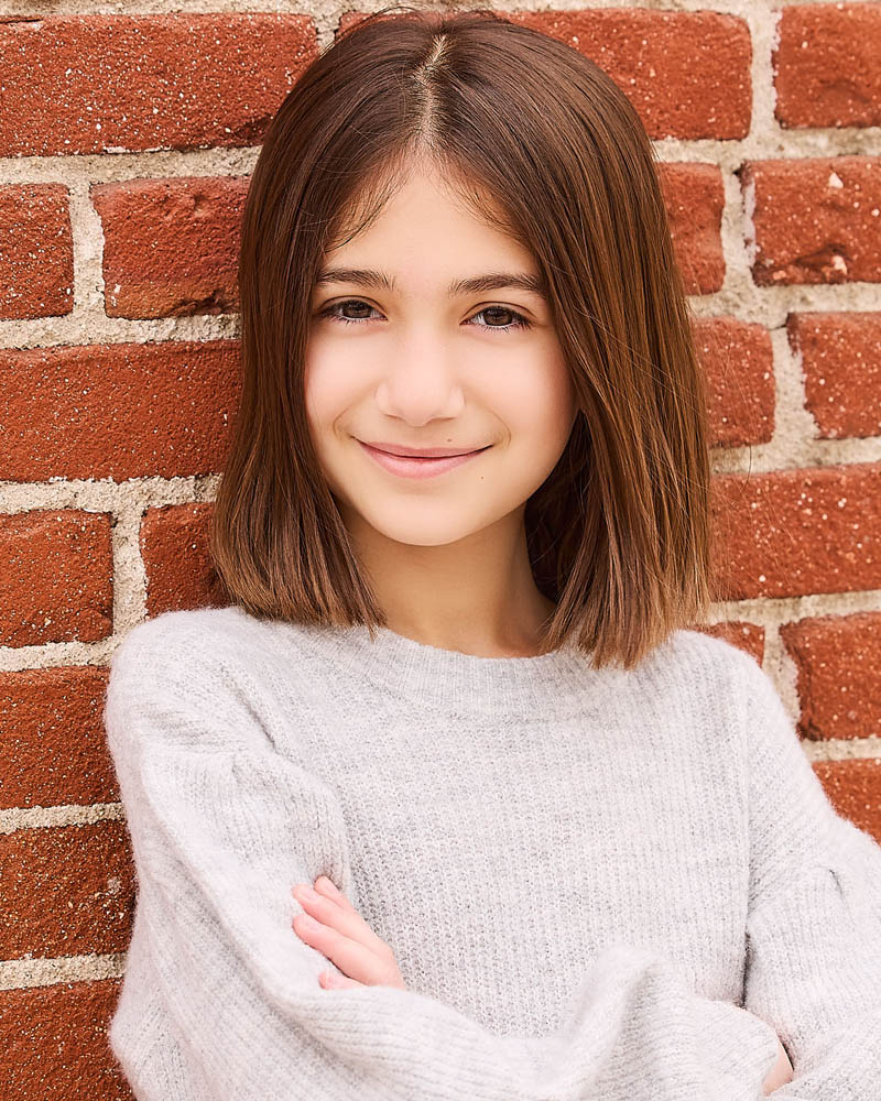 young girl acting headshot in a studio near Burbank with a brick wall background