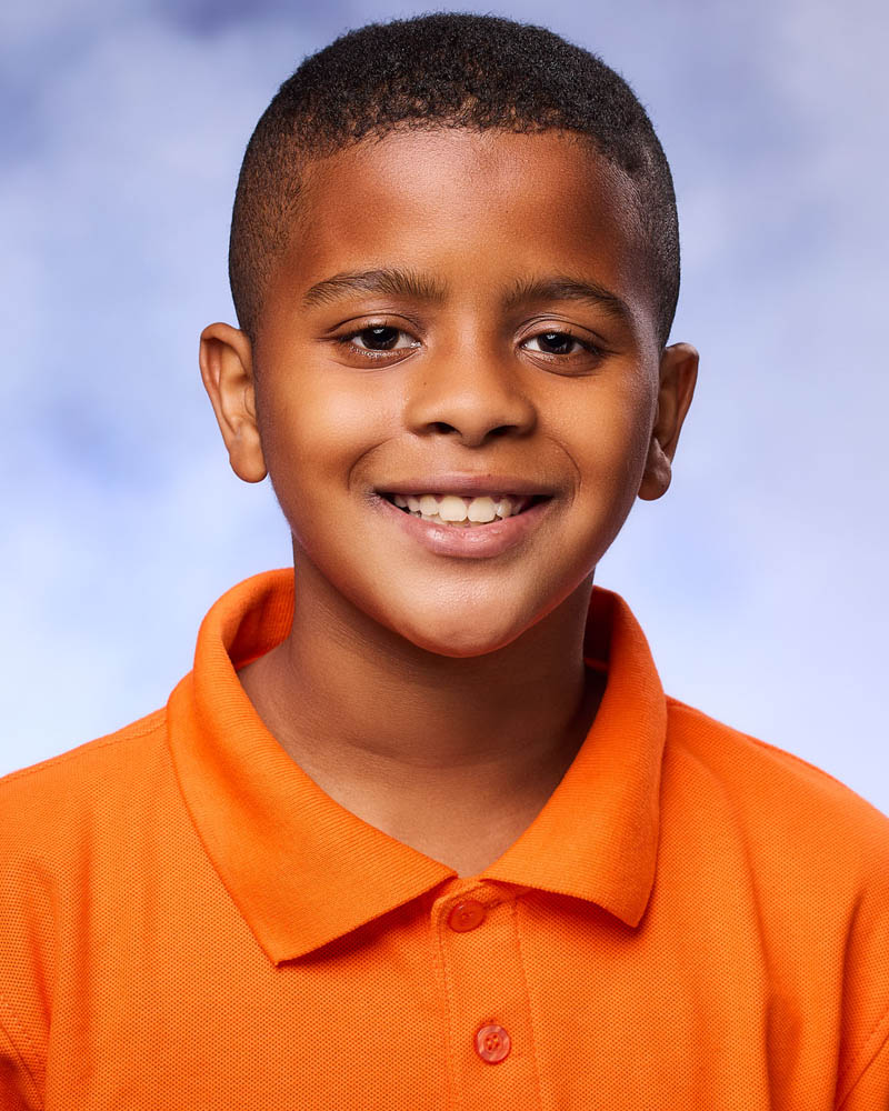 A headshots for kid actors of a young boy in a studio in Los Angeles
