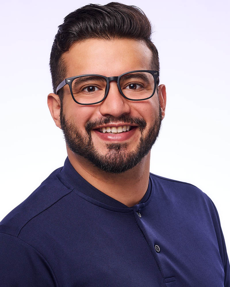 men studio professional headshots in Los Angeles against a white background wearing glasses