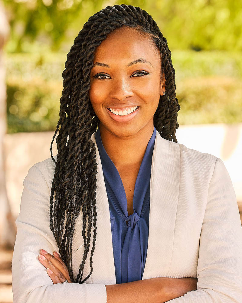 A business headshot of a black woman in a suit in natural light near Sherman Oaks