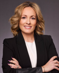 A real estate agent headshot of a woman in a suit in studio near Los Angeles