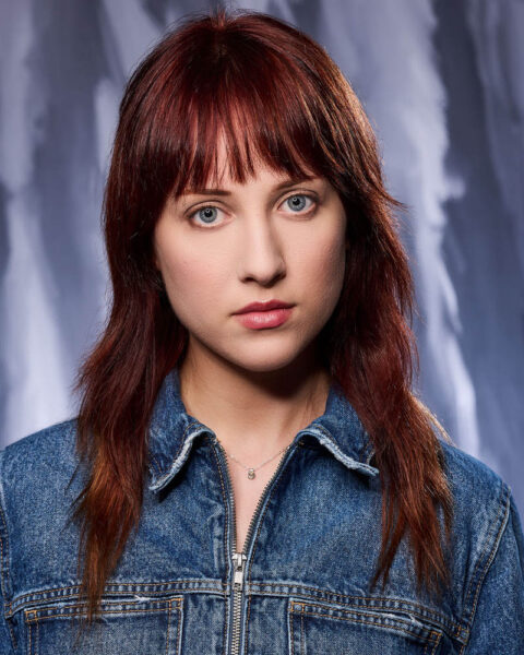 A theatrical actor headshot of a woman in a jean jacket in a studio near Pasadena