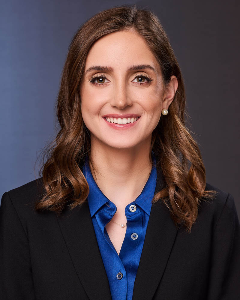 A corporate headshot of a finance executive woman in a suit in studio in Glendale